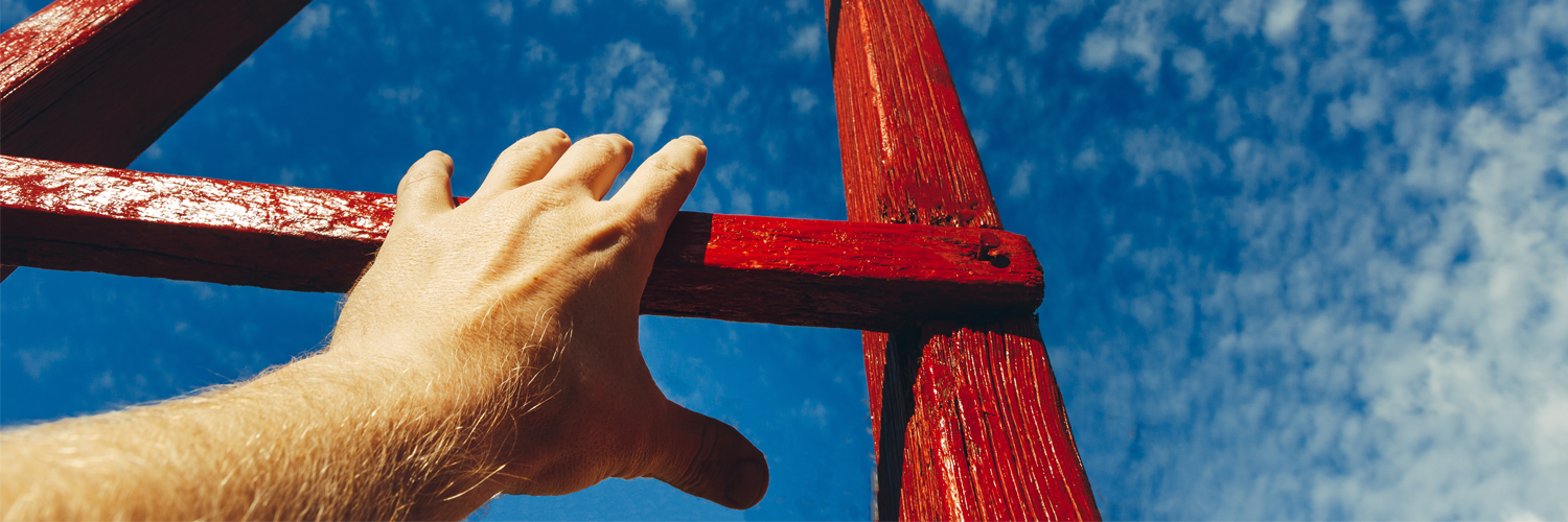 hand+of+man+reaching+for+red+ladder+leading+to+a+blue+sky